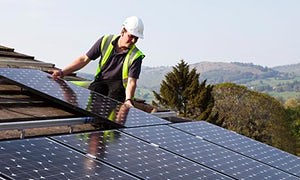 Fitting solar pv panels to house roof Wales UK