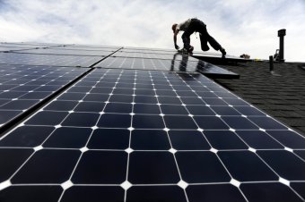 Solar installer, Justin Woodbury, Namaste (accent over the e) Solar, secures solar panels for a photovoltaic solar array system on the roof of a house in the Sorrel Ranch area, near e-470 and Smoky hill Road in Aurora Friday afternoon in record temperatur