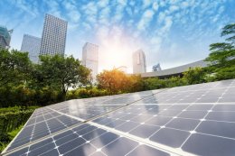 Solar panels with a city skyline in the background.